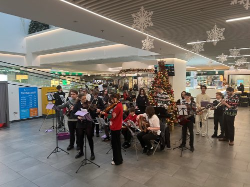 Local orchestra brightens up the mall with music and carols